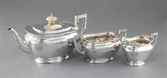 An Edwardian Art Nouveau matched silver three piece tea set, teapot height 112mm, gross weight 23.5oz/731grms.